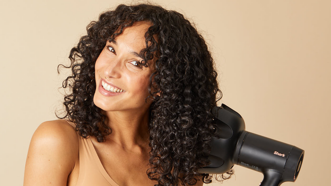 Woman with curly hair using a diffuser